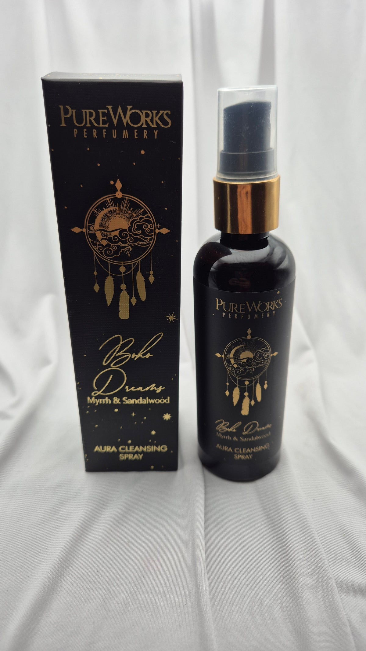 PureWorks Perfumery 'By The Dream' Myrtle & Sandalwood Aura Cleansing Spray, shown with its black packaging box and the dark glass spray bottle featuring gold lettering and a gold collar.