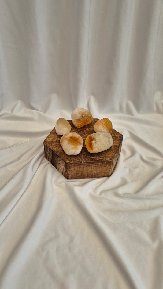 Wooden box with stones on a white fabric background